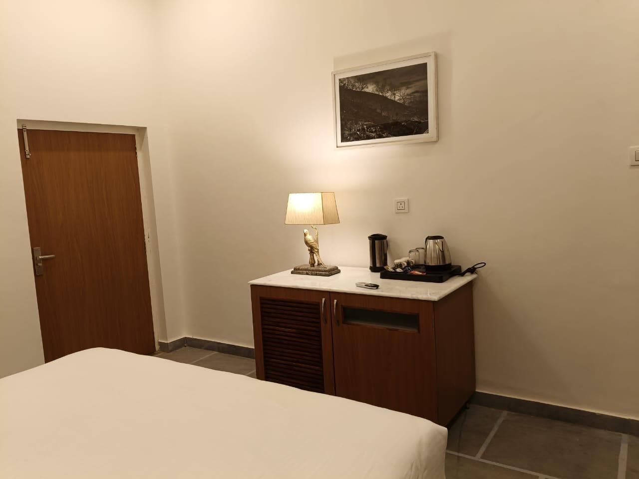 The Courtyard Room at Shivbagh, its doors open to a shaded stone courtyard